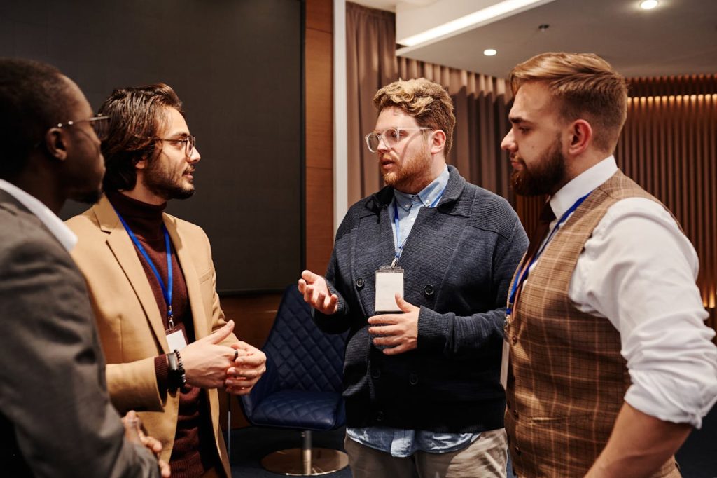 A diverse group of professionals engaged in a business meeting discussion indoors.